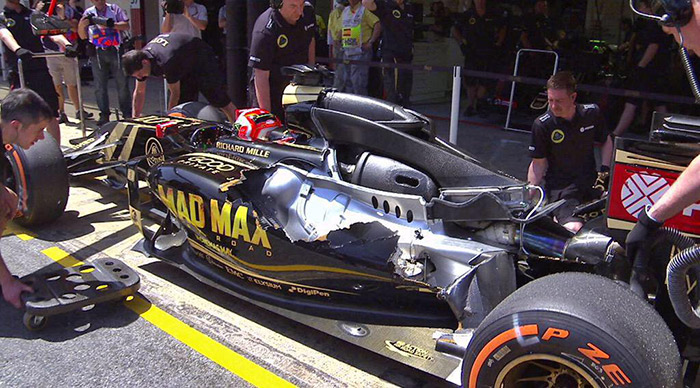 Lotus E23 in the pits at the British GP after bodywork flew off the car