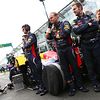 Red Bull mechanics protecting car on grid