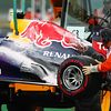 The fire damaged Red Bull Racing RB9 of race retiree Mark Webber
