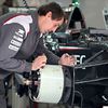 Sauber F1 Team mechanic works on the Sauber C33 brake