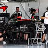 The McLaren MP4-30 is prepared in the pit garage
