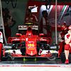 Ferrari mechanics sit by the Ferrari SF15-T of Kimi Raikkonen